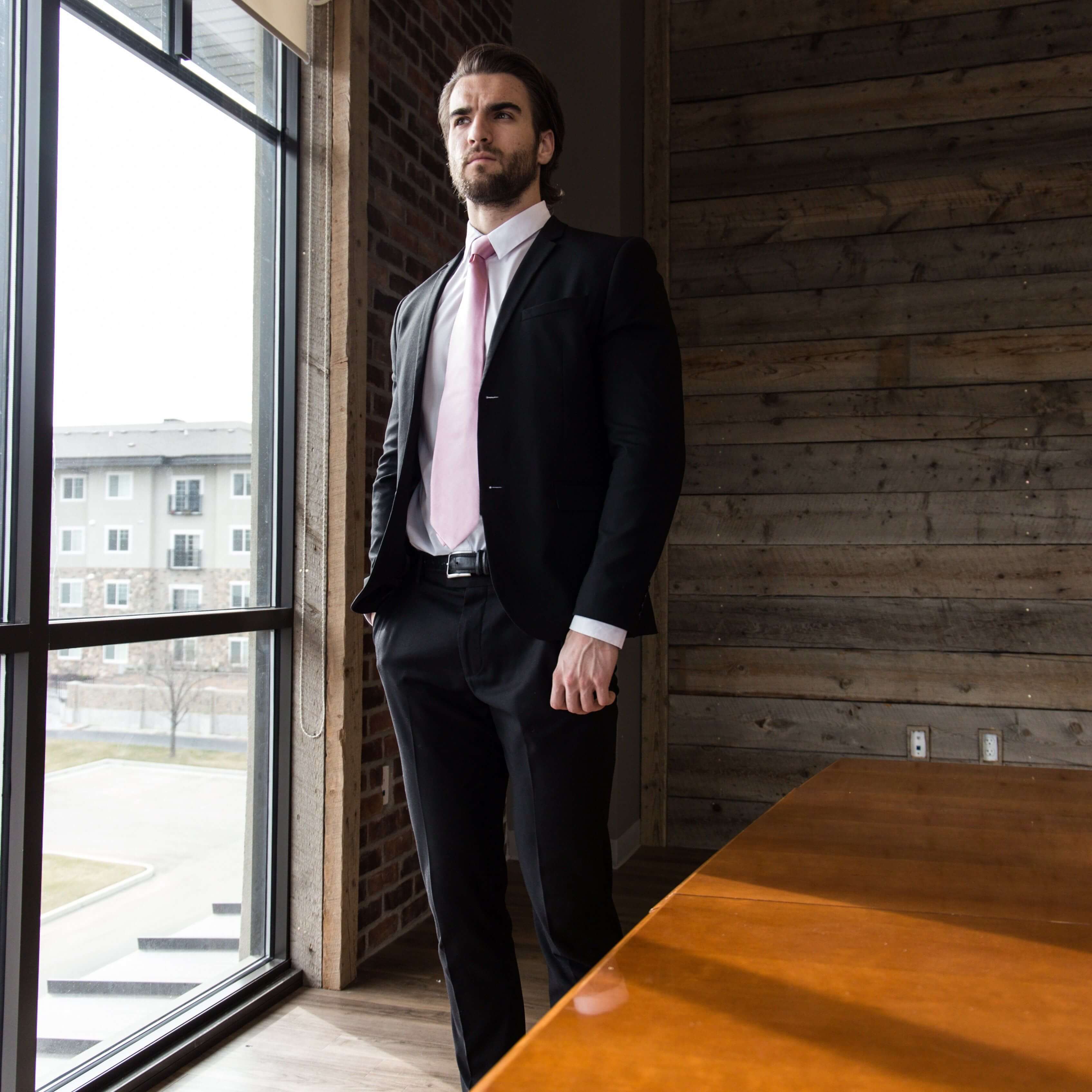 Lifestyle shot of man wearing pink solid tie